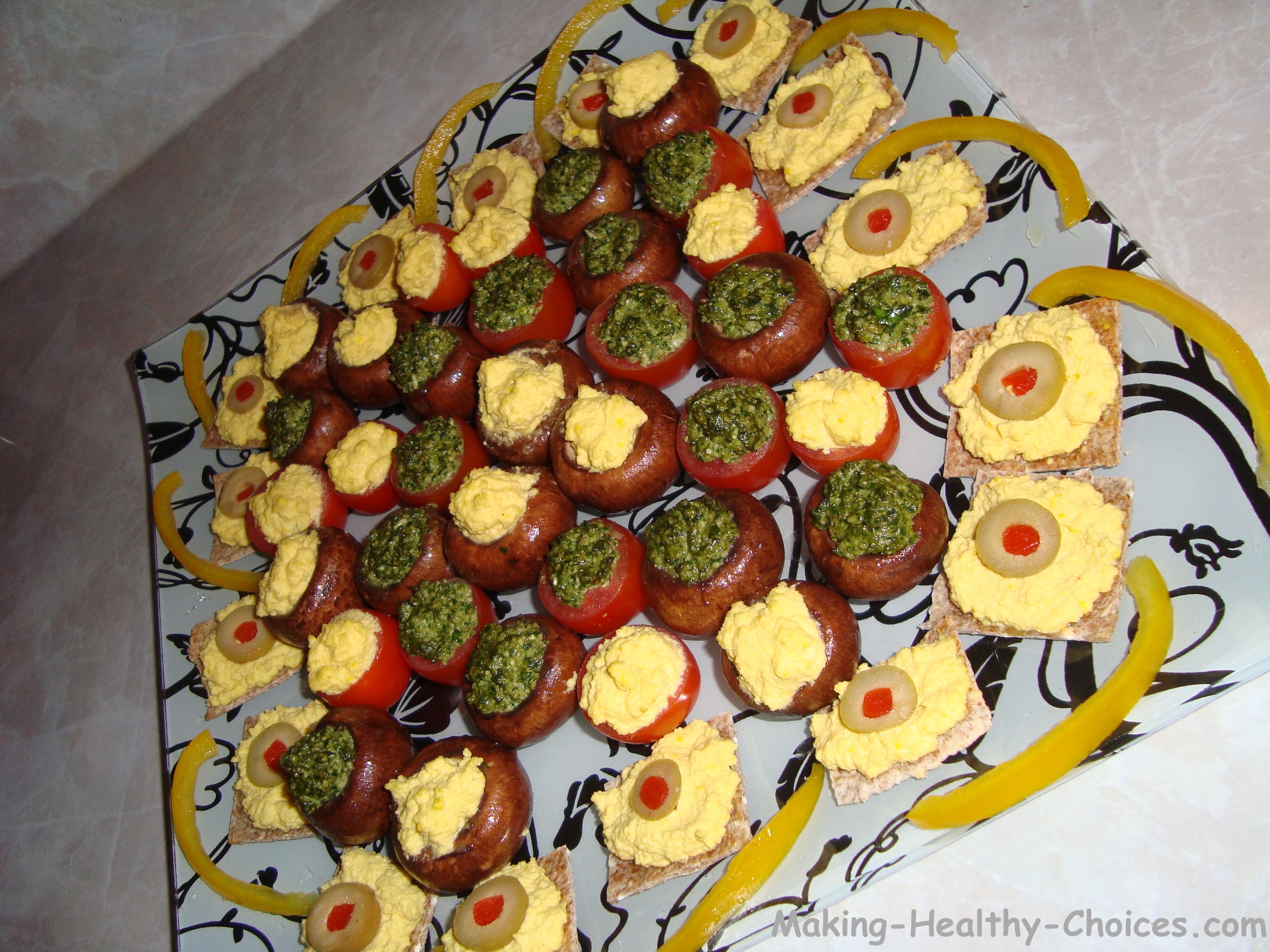 Stuffed mushrooms with raw vegan pesto or raw vegan cheese sauce; a healthy appetizer that is raw and vegan.